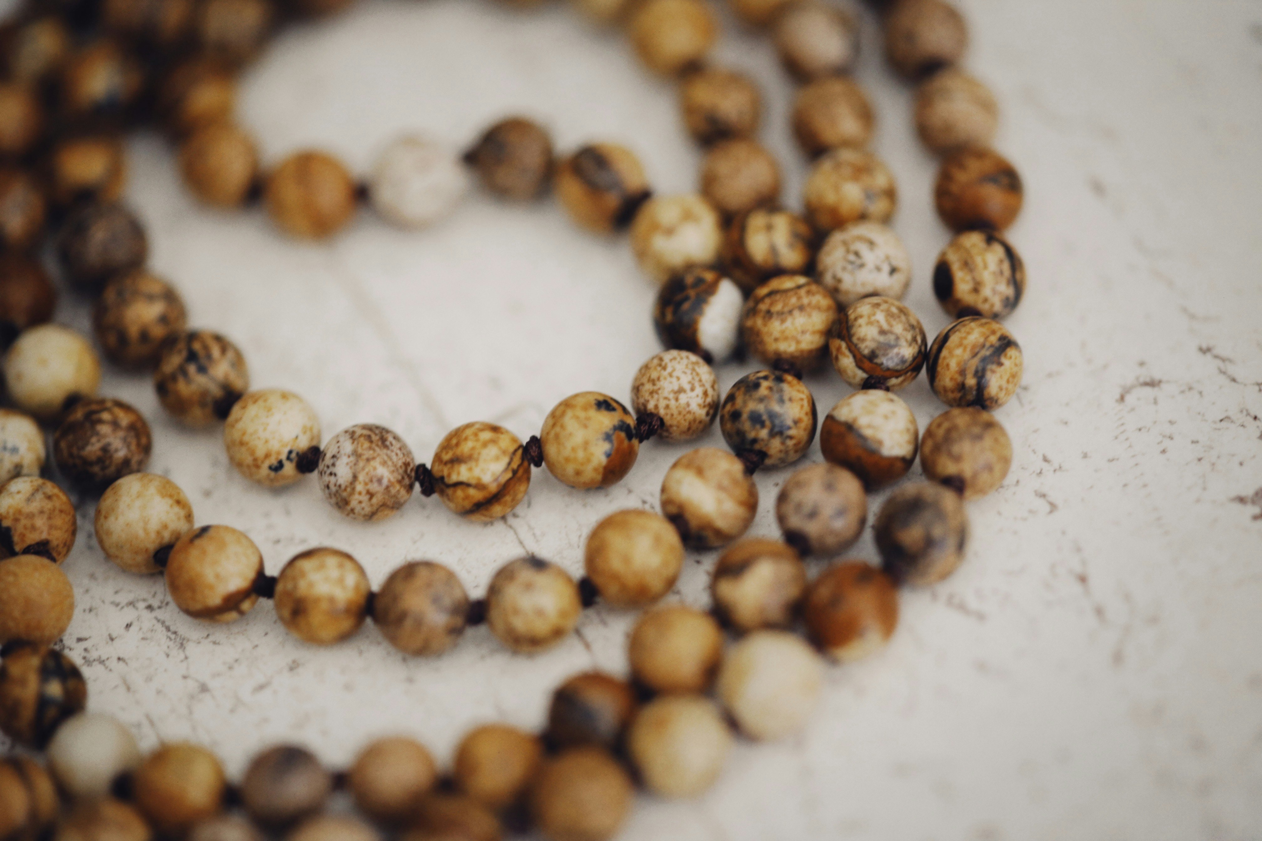 brown coffee beans on white surface